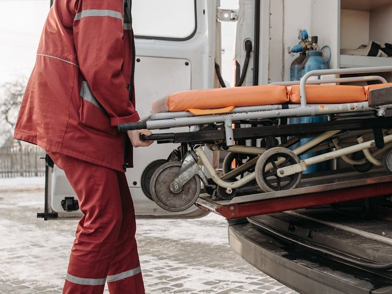 Medical transport team loading a stretcher